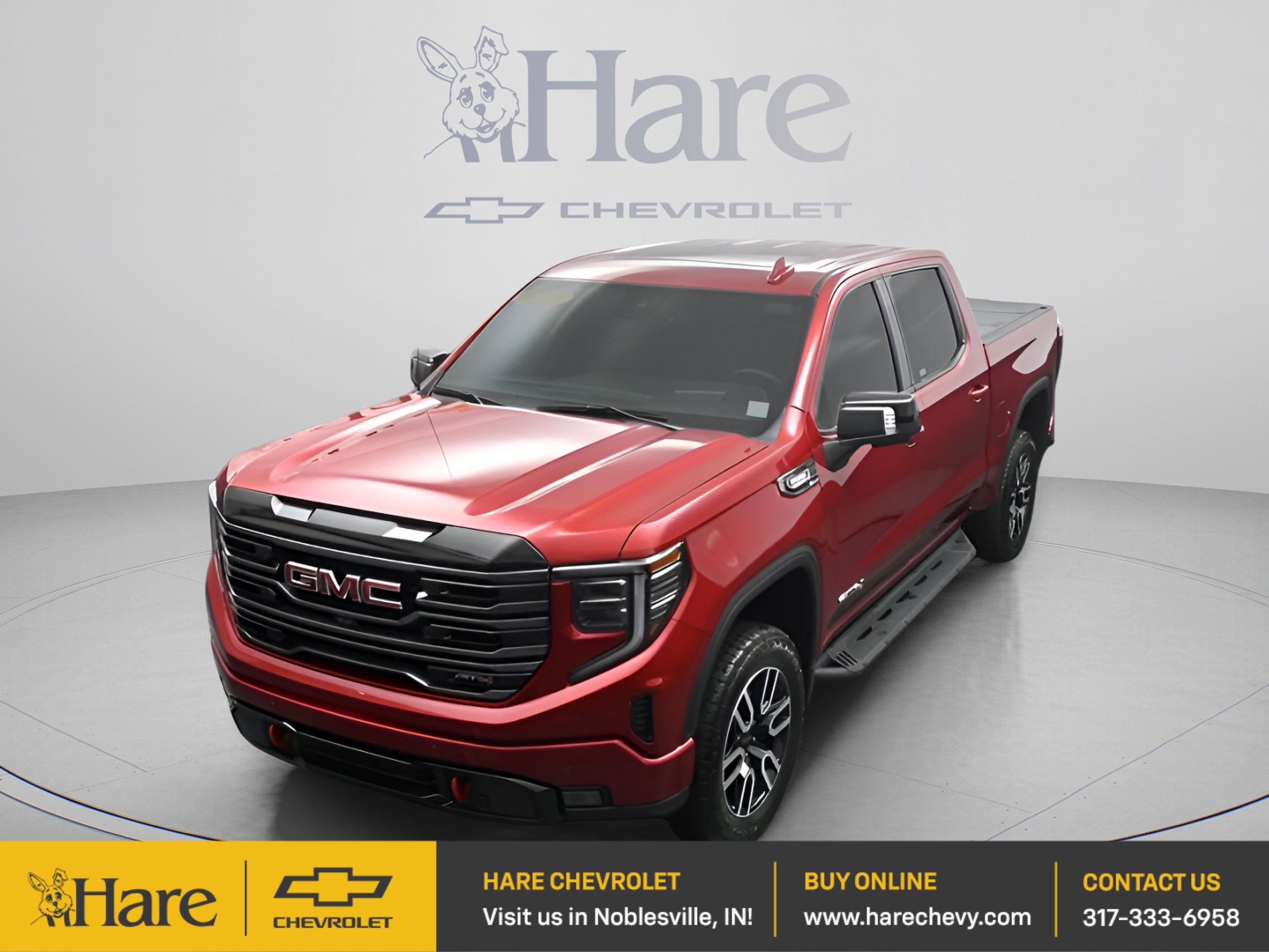 2025 GMC Sierra 1500 AT4 in Volcanic Red Tintcoat — front three-quarter view