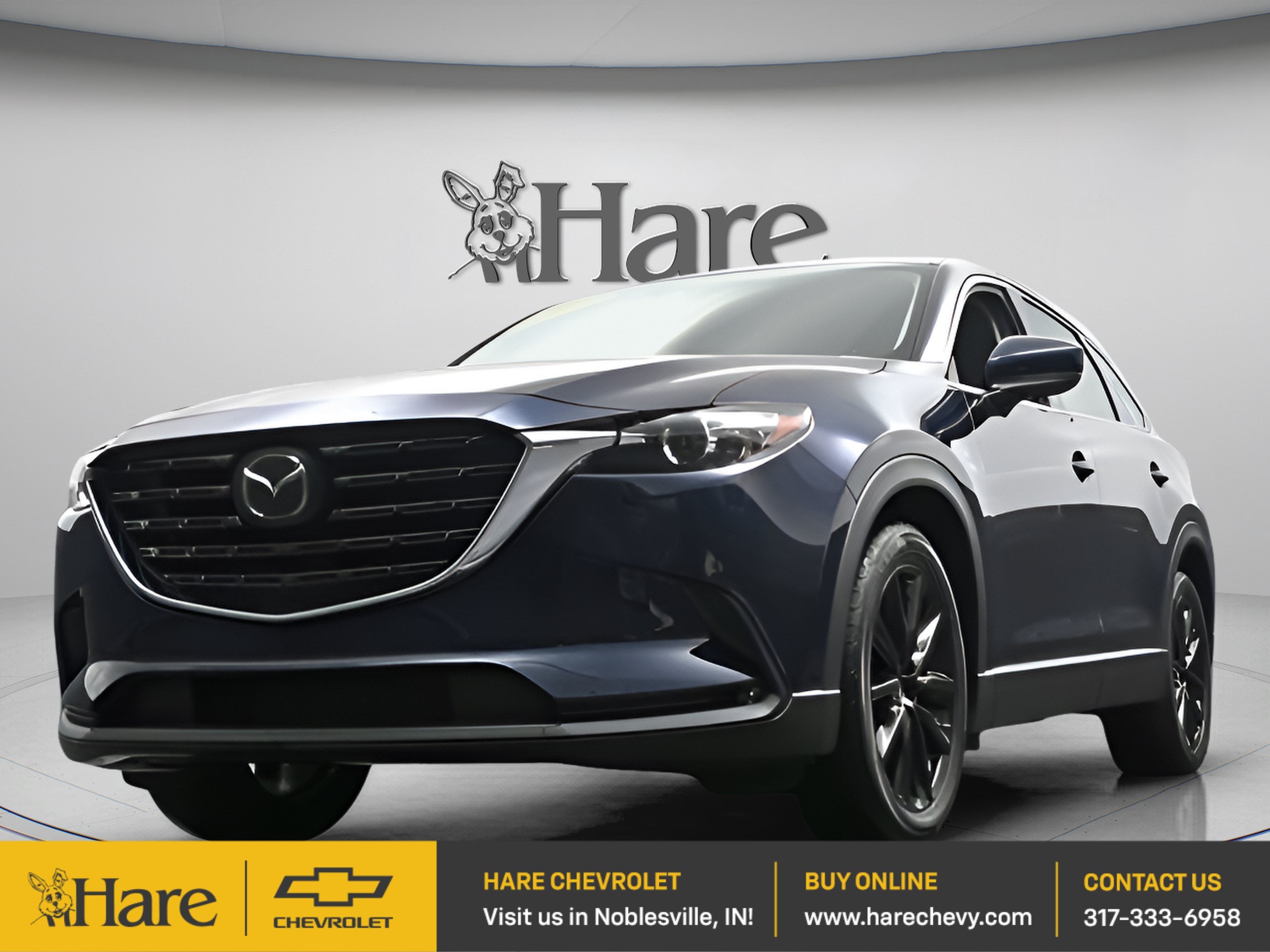 2023 Mazda Mazda CX-9 Touring Plus in Blue — front three-quarter view